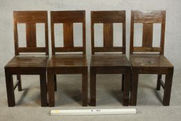 A set of four contemporary hardwood dining chairs, with solid seats on square section legs joined by