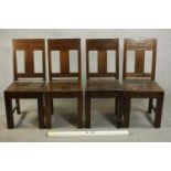 A set of four contemporary hardwood dining chairs, with solid seats on square section legs joined by