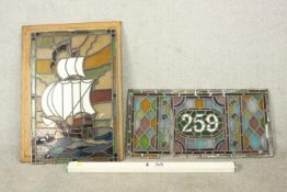 Two early 20th century stained glass panels, one depicting a sailing ship, the other the house