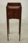 A 19th century mahogany night table, with a gallery top over a cupboard door, on slender tapering