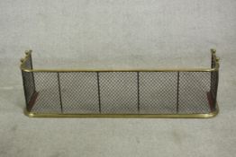 A Victorian brass fireguard or fender with a mesh grille. H.31 W.118 D.31cm.