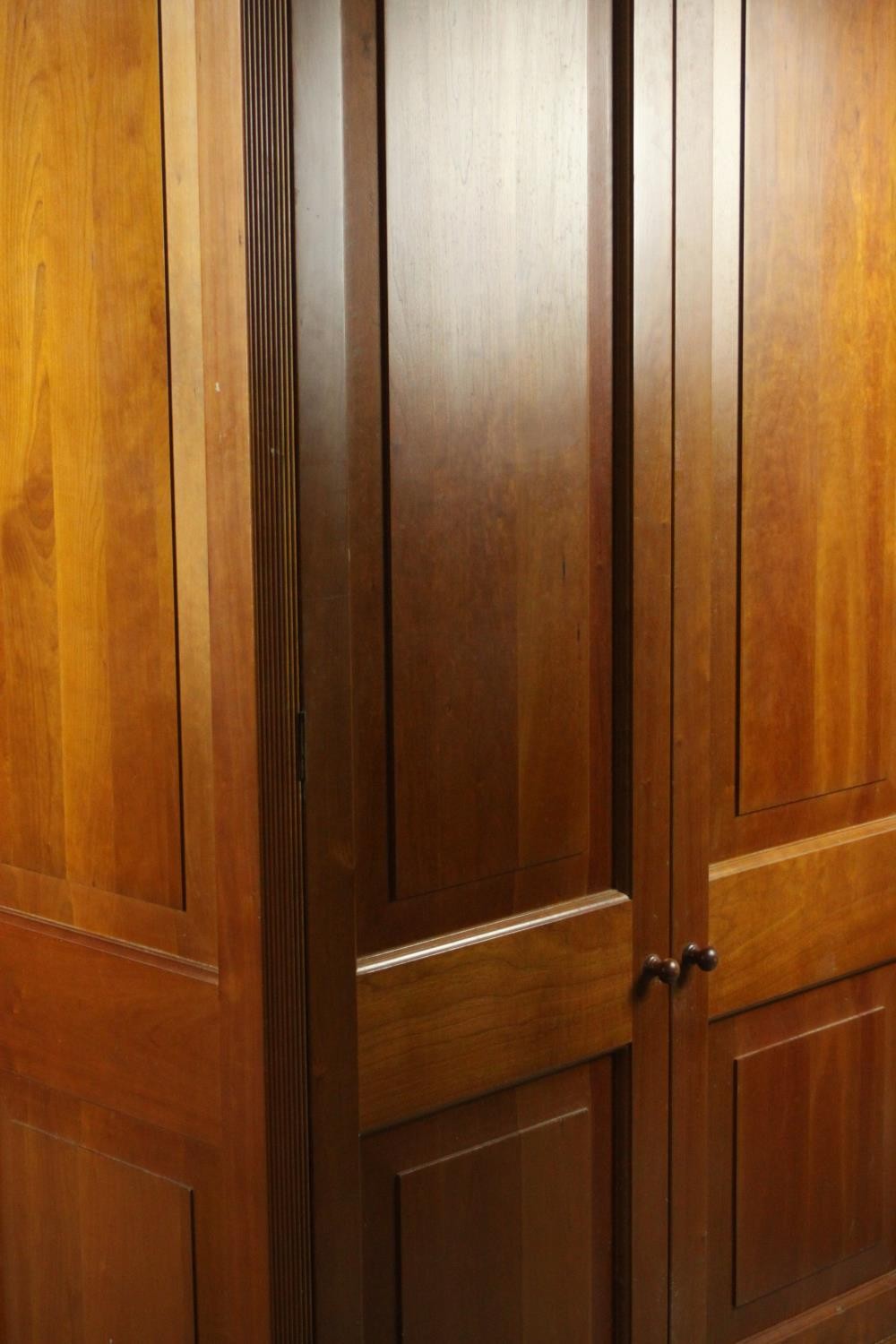 A late 20th century cherrywood wardrobe, with a pair of panelled doors opening to reveal hanging - Image 11 of 13