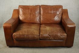 A late 20th century brown leather two seater sofa by Raft, with angular arms, on bun feet. H.86 W.