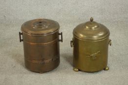 A brass coal bucket and a copper coal bucket, both of cylindrical form with a lid and two handles.