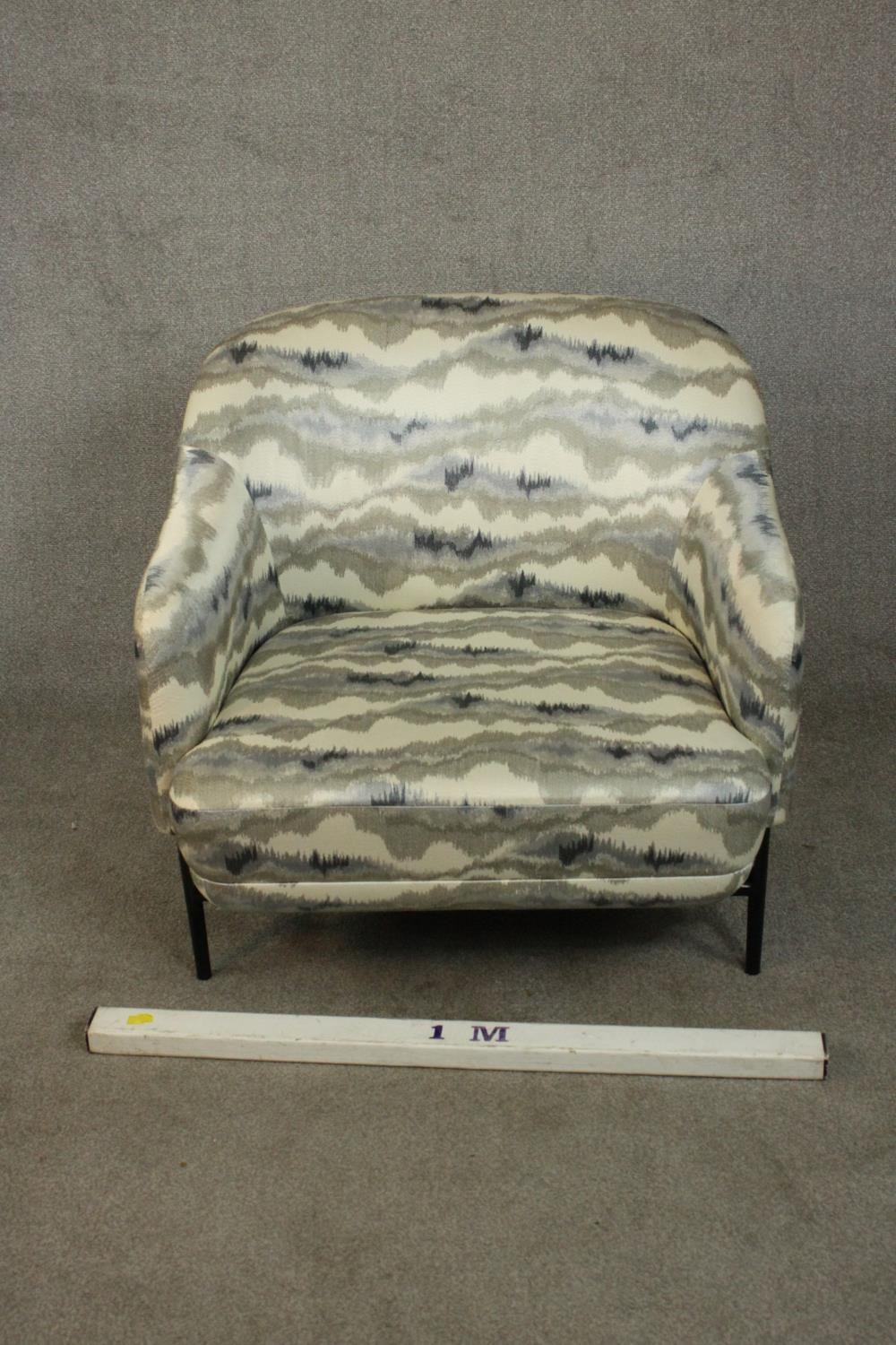 A pair of retro styled armchairs, with patterned upholstery in hues of grey, on a black powder - Image 10 of 13