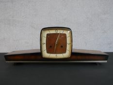 A circa 1950s mantle clock, of elongated form, the dial with Arabic numerals. H.21 W.57 D.13cm