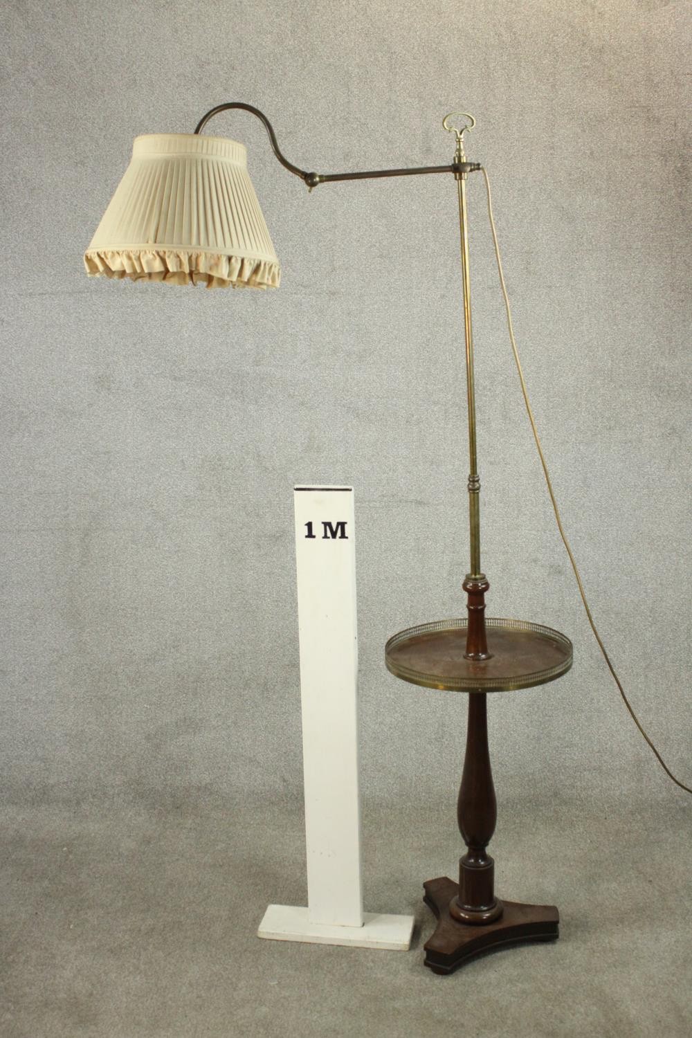 An adjustable standard lamp, with a brass arm and stem, over a circular tier with a pierced brass - Image 2 of 5