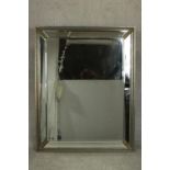 A large contemporary rectangular mirror, with a bevelled mirror plate in a sectional bevelled mirror