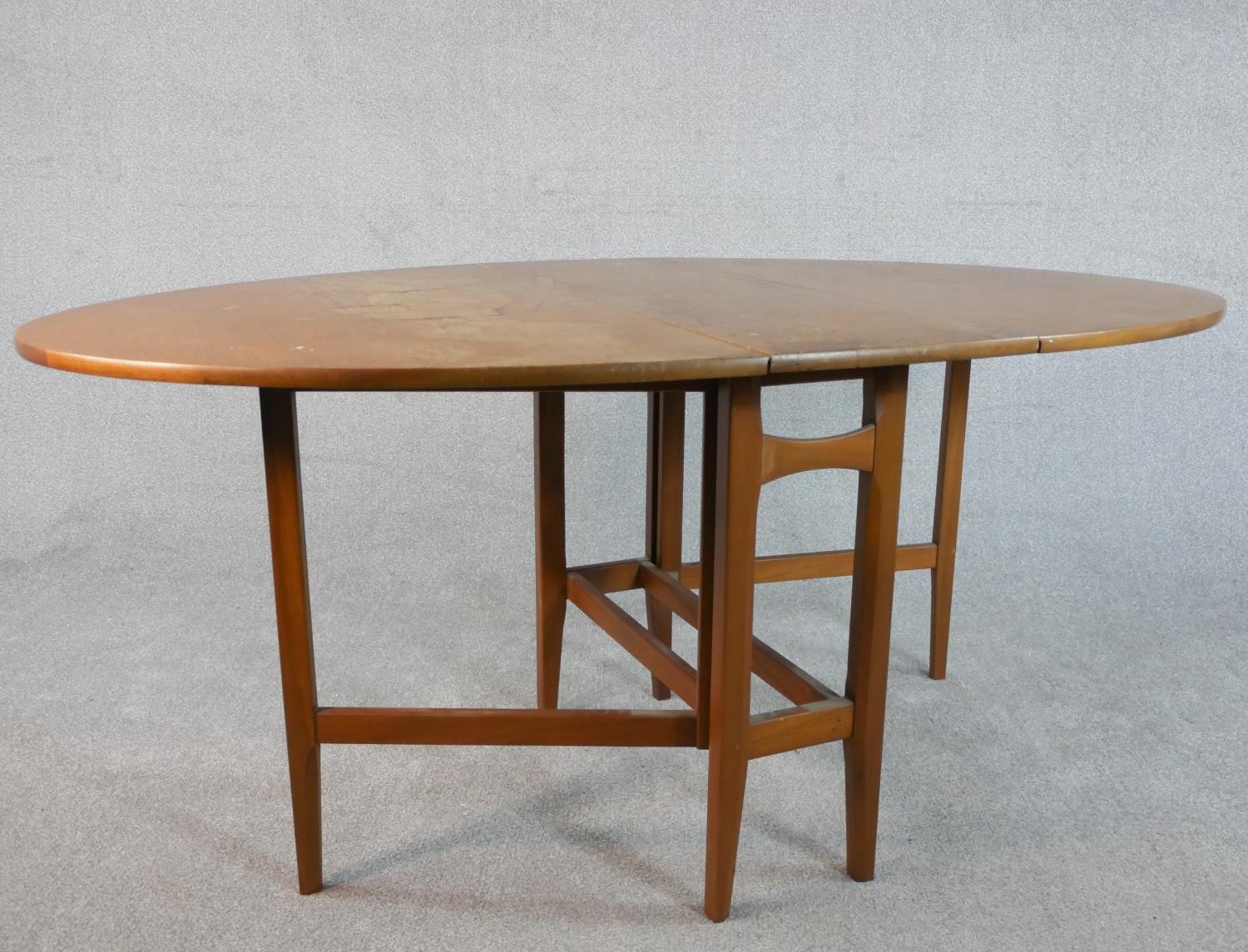 A late 20th century teak drop leaf dining table, the top of oval form with gateleg supports. H.74 - Image 3 of 5