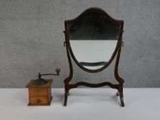 An Edwardian shield shape mahogany framed dressing mirror along a French Japy Freres and Co coffee