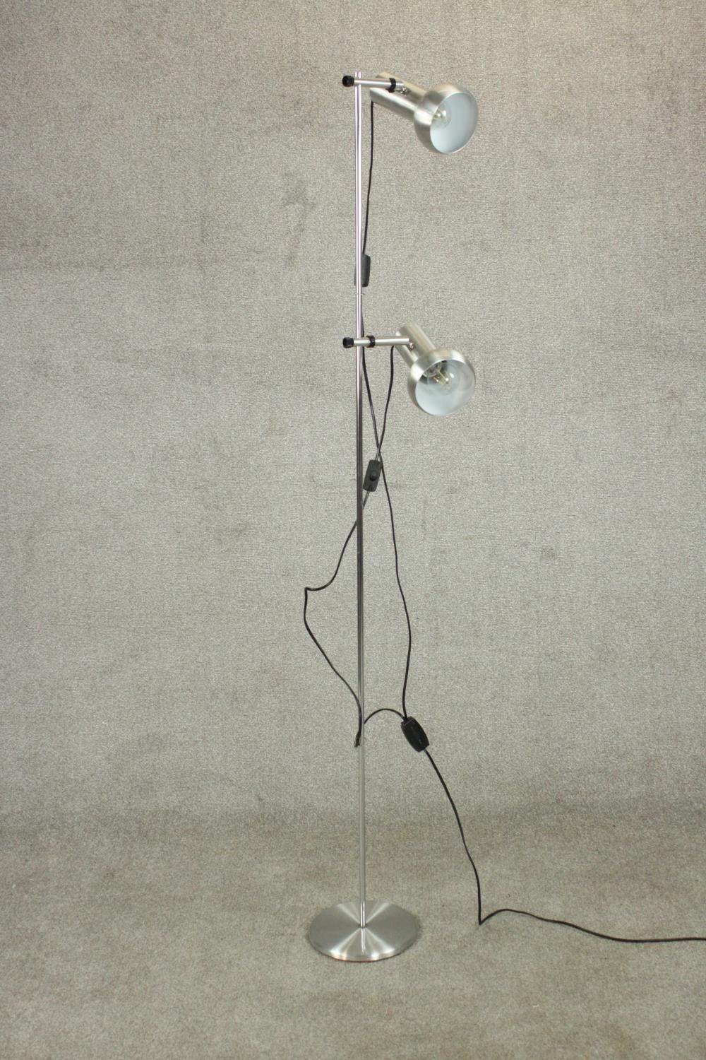 A brushed chrome adjustable twin spotlight floor standing lamps. H.170 Dia.24cm.