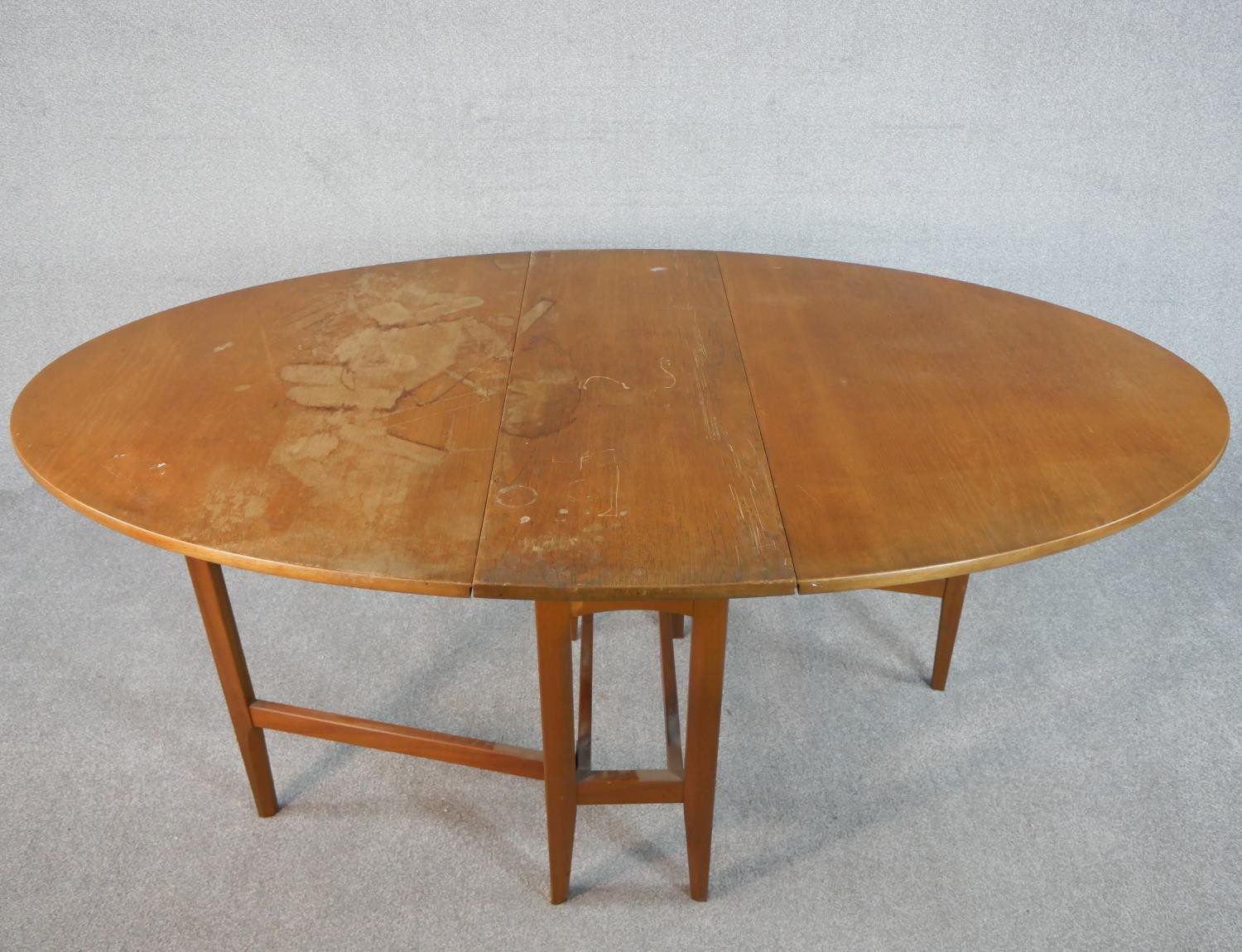 A late 20th century teak drop leaf dining table, the top of oval form with gateleg supports. H.74 - Image 2 of 5