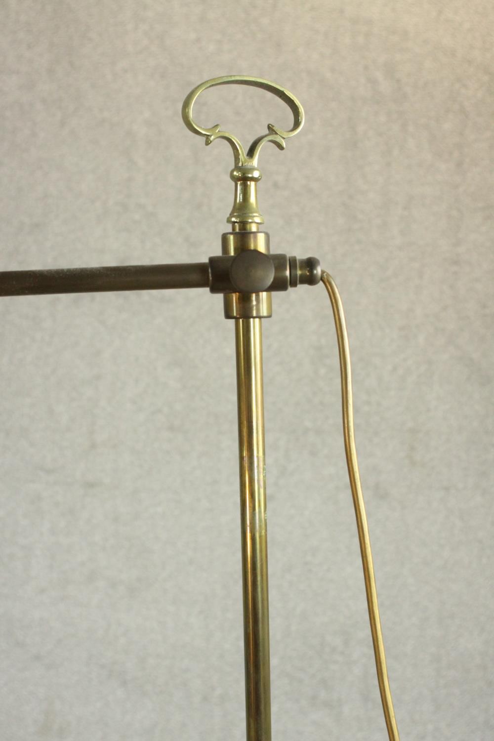 An adjustable standard lamp, with a brass arm and stem, over a circular tier with a pierced brass - Image 4 of 5