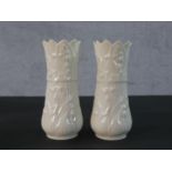 A pair of Belleek vases, with flared rims and moulded decoration along with a Belleek jug, with a