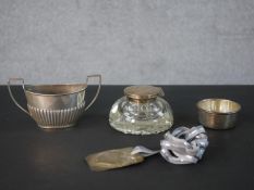 A collection of silver items, including a silver twin handled gadrooned sugar bowl, a silver