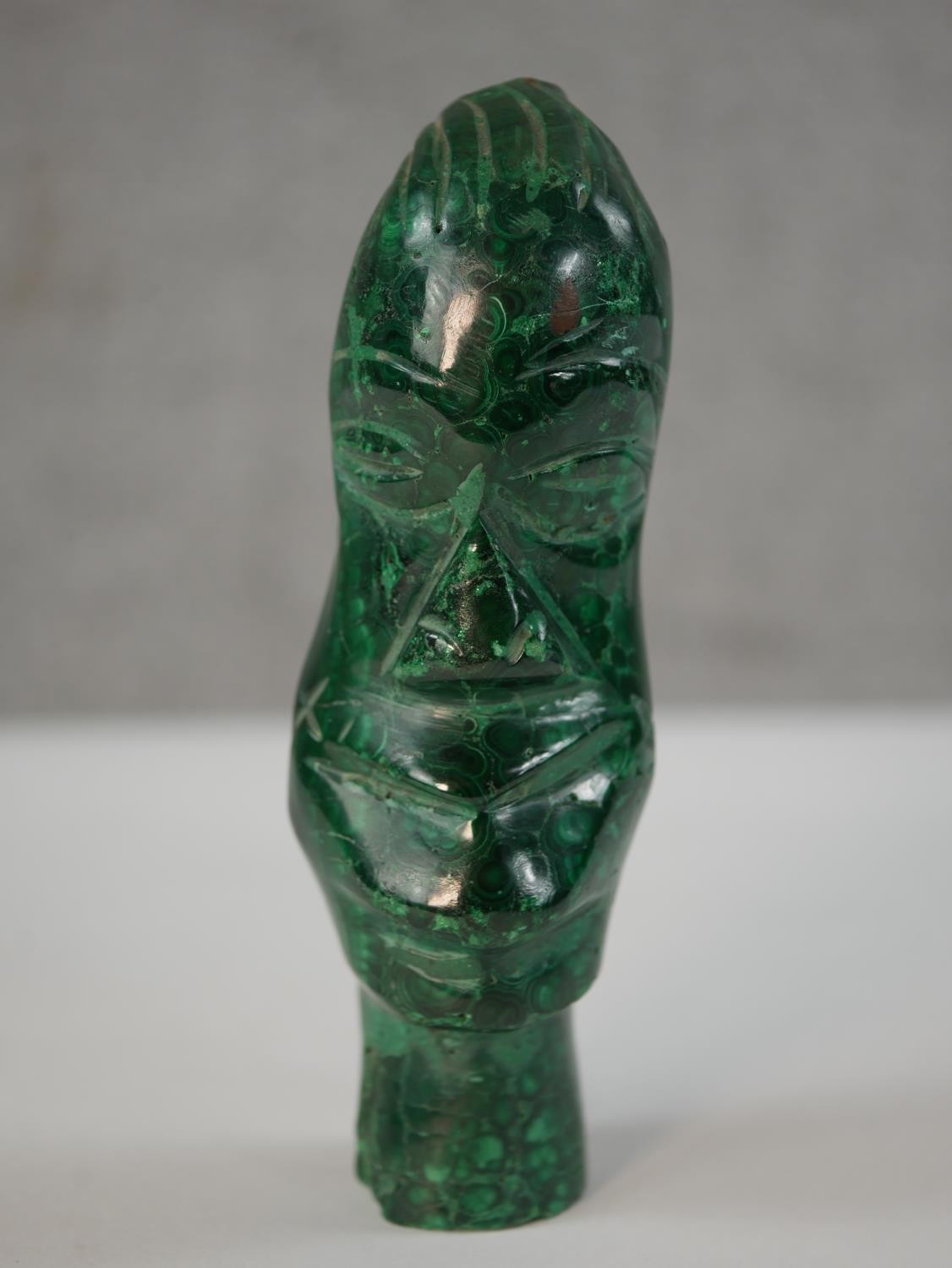 A carved malachite African tribal head. H.15cm
