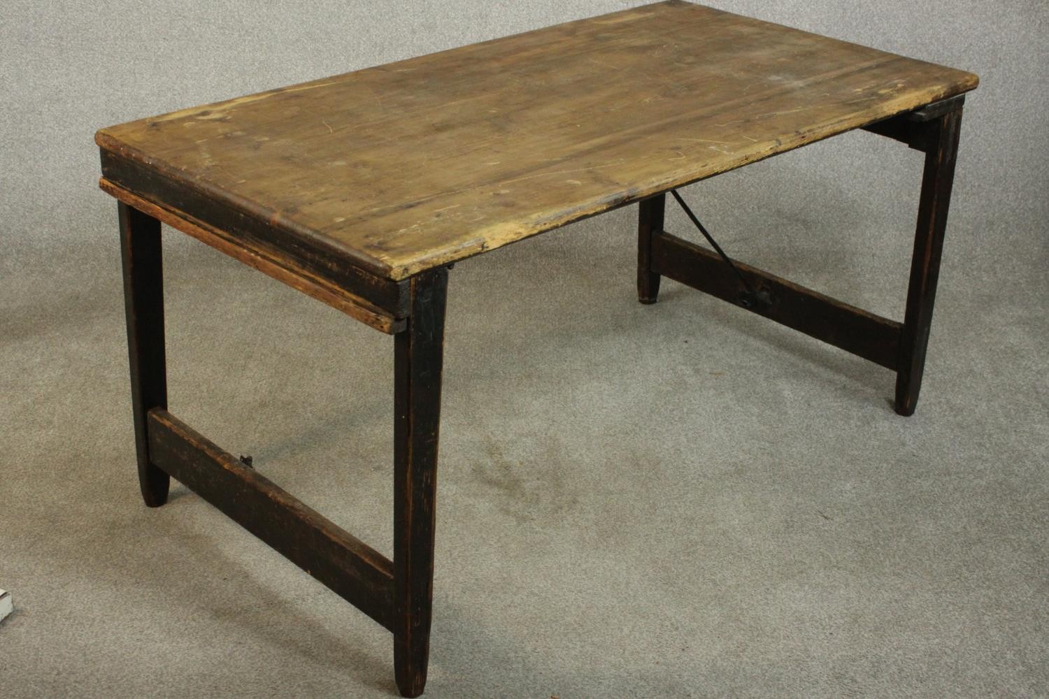 A pine folding trestle table, with a rectangular plank top on folding end supports. H.68 W.136 D. - Image 3 of 8