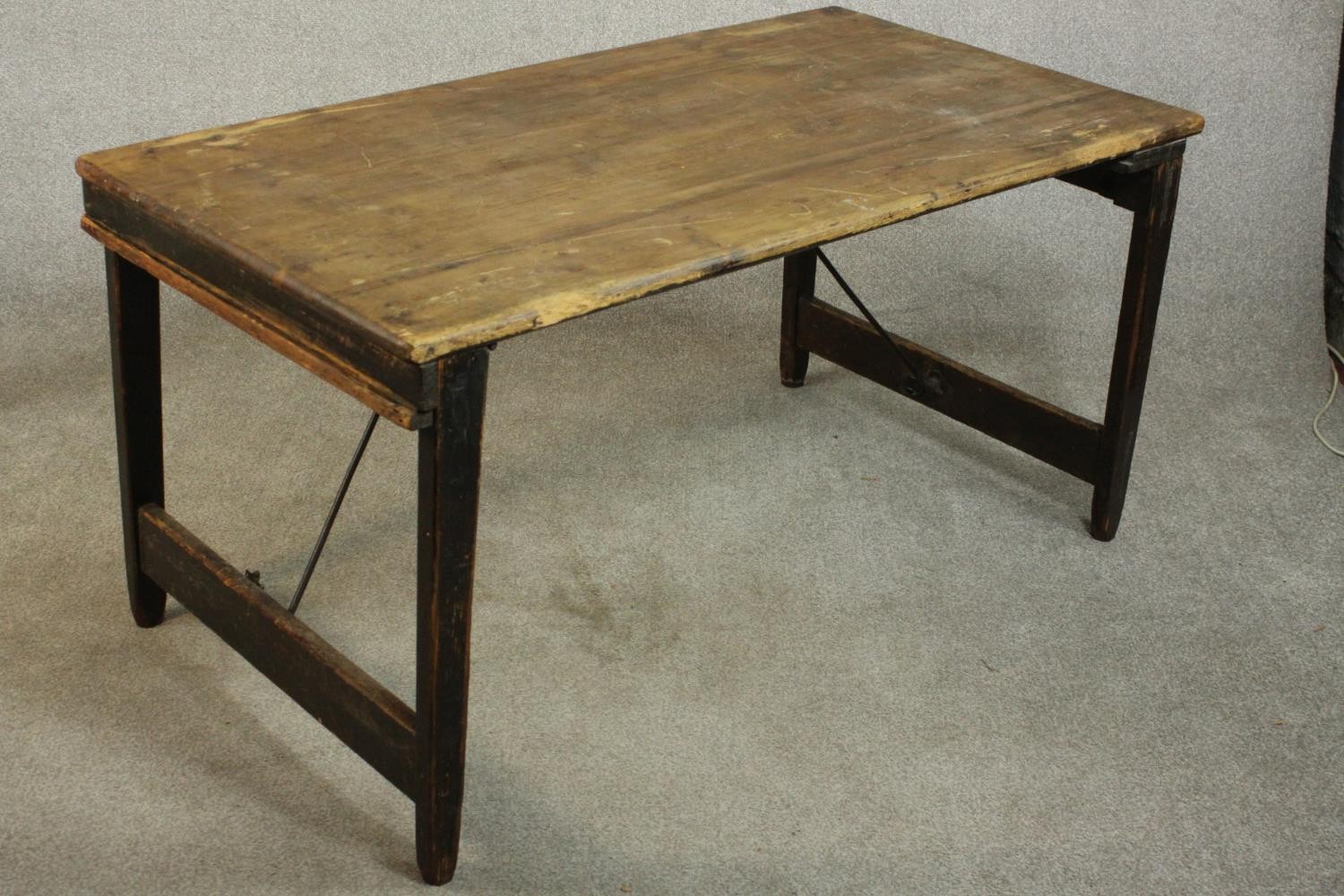 A pine folding trestle table, with a rectangular plank top on folding end supports. H.68 W.136 D. - Image 4 of 8