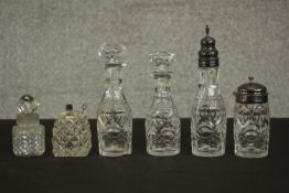 A four piece 19th century cut crystal cruet set with silver tops along with a cut glass perfume