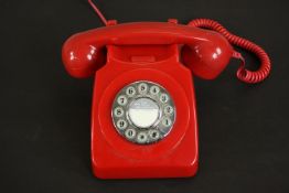 A vintage style red acrylic dial up telephone. H.13 W.13 D.21cm.