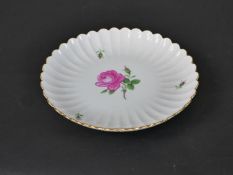 A 20th century Meissen porcelain dish, circa 1930, with a scalloped edge, painted to the centre with