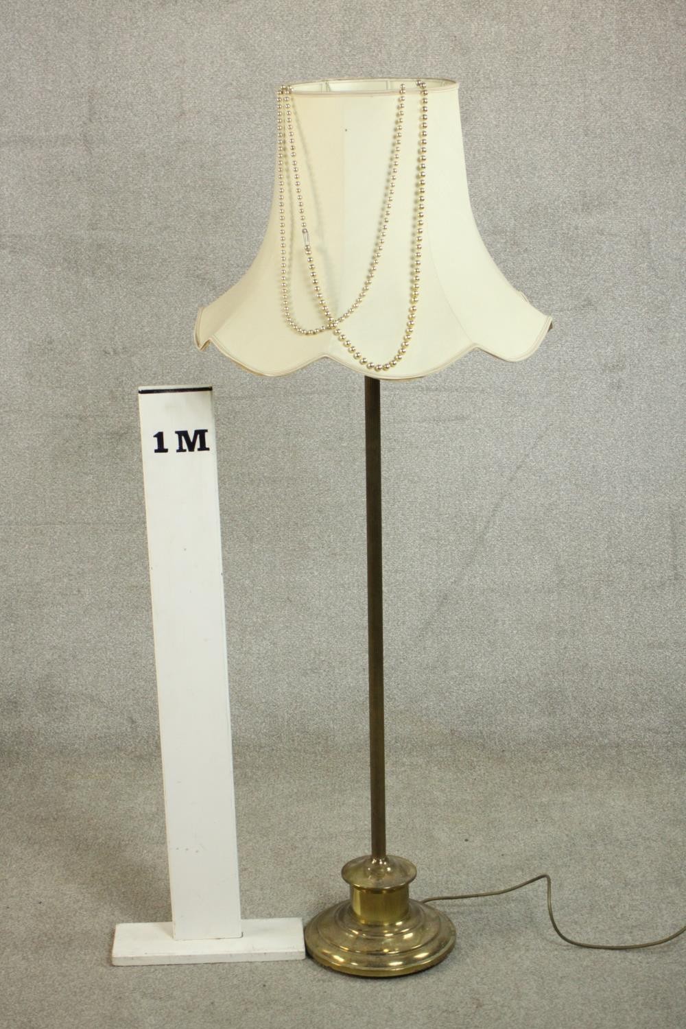A 20th century standard lamp with a circular brass base and a white shade. H.147 Dia.59cm. - Image 2 of 4
