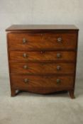 An early 19th century flame mahogany secretaire chest, with a secretaire drawer over three long