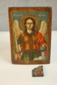 A painted religious icon on panel of St Michael Archangel, along with a smaller icon. H.29 W.19 D.