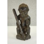 An early 20th century carved African figure from the Democratic Republic of Congo with fabric