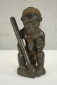 An early 20th century carved African figure from the Democratic Republic of Congo with fabric