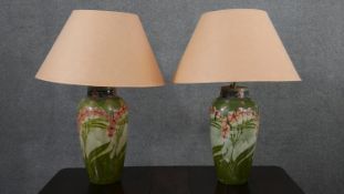 A pair of Minton Secessionist lamps with tube line stylised floral design on a green ground. Green