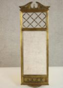 A Regency giltwood pier mirror, with a broken pediment over a grille panel above a rectangular