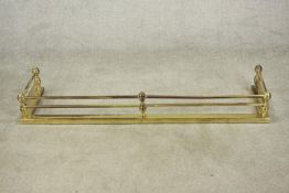 A Victorian brass fender of typical form with ball supports to the tubular rails. H.18 W.134 D.36cm.