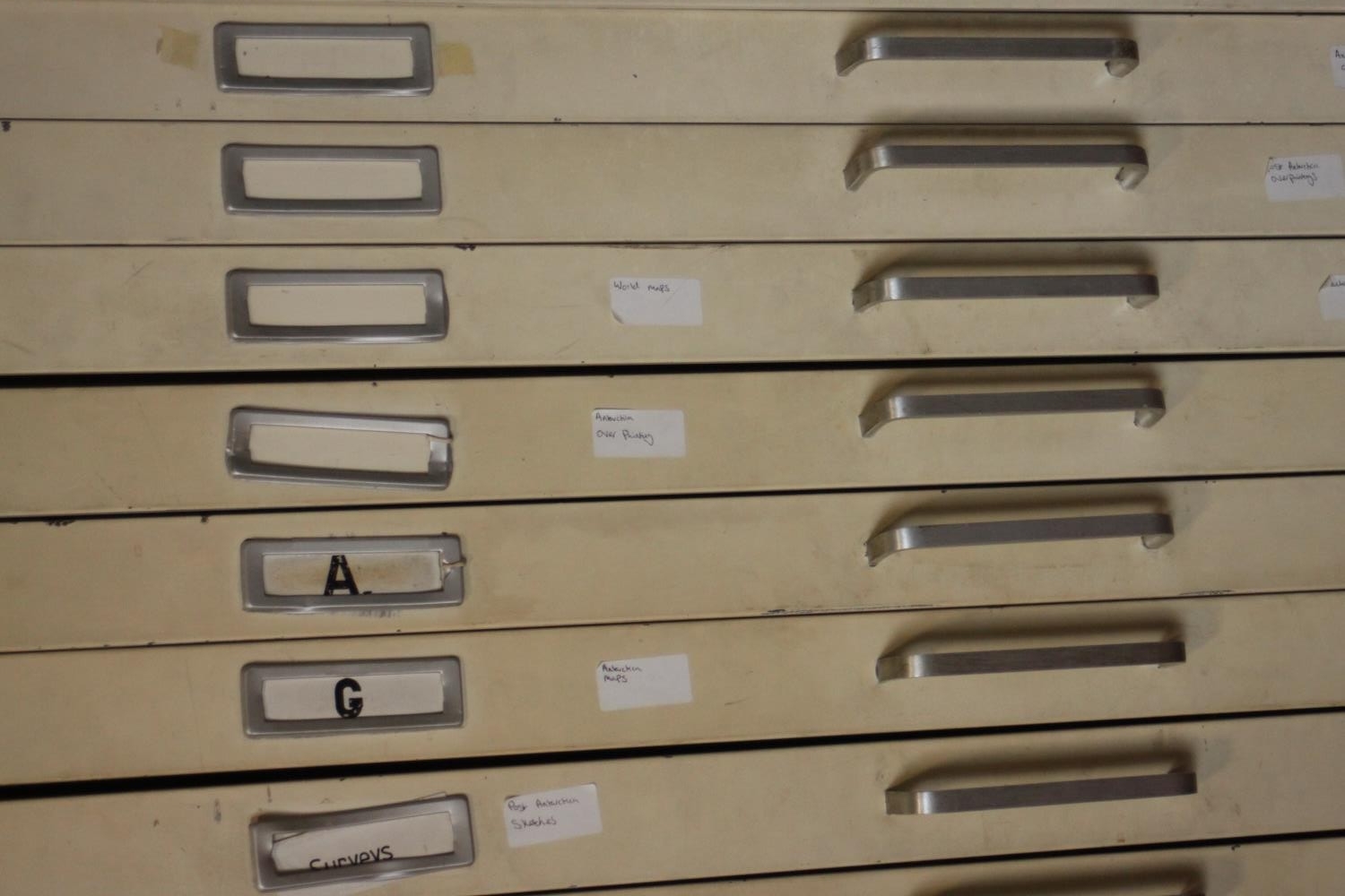 A painted steel plan chest, mid 20th century, the frame black, the ten long drawers painted beige. - Image 4 of 7