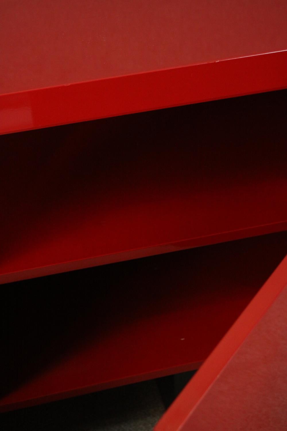 A contemporary red lacquered sideboard with two cupboard doors, on black lacquered supports. H.74 - Image 7 of 14