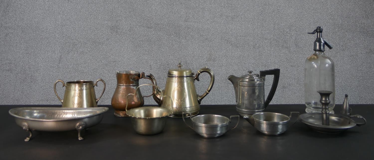 A collection of metal ware, including a vintage soda siphon, a silver plated engraved tea set, a