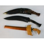 A Malay kris dagger, together with two Gurkha kukri knives. L.45cm (largest)