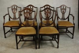 A set of six Hepplewhite style mahogany shield back dining chairs, comprising two carvers and four