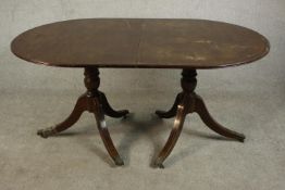 A George III style mahogany D end dining table, with an additional leaf, on turned supports with