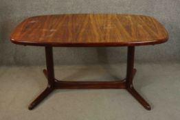 A 1960's Rasmus vintage Danish rosewood extending dining table with two extra leaves on stretchered