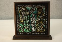 A framed Gothic style painted on glass copy of a religious stained glass window panel, mounted on