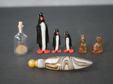 Two Victorian glass cracker charms (cat and rabbit), a set of art glass penguins, a blown glass