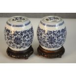 Two blue and white miniature porcelain lidded jars in the form of Chinese stools with stylised