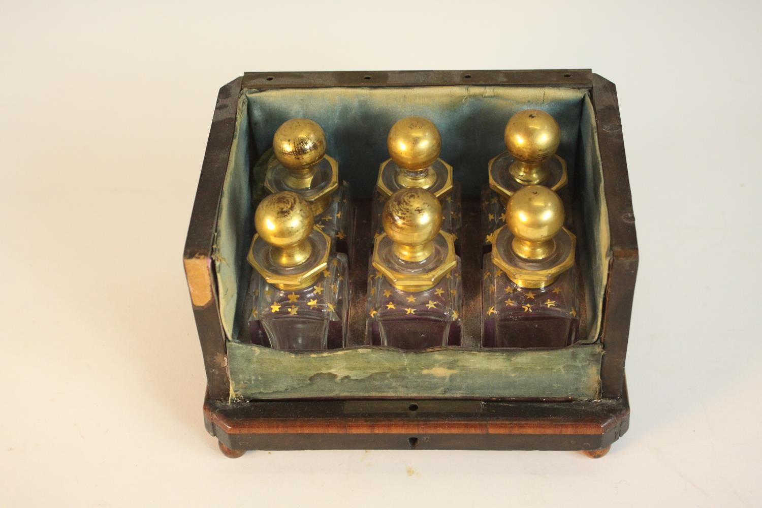 A 19th century six bottle perfume box, inlaid with burr wood panels, missing the front and lid, with