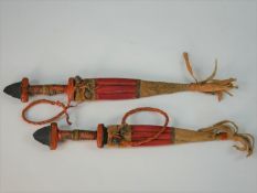 Two African Sudan Coutea Tebu daggers in leather sheaths. L.30cm (largest)