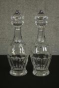 A pair of 19th century Waterford crystal decanters, with cut sections to the stopper, neck and body,