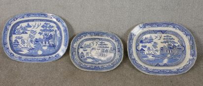 Three large 19th century blue and white Chinese willow pattern transfer design meat platters.