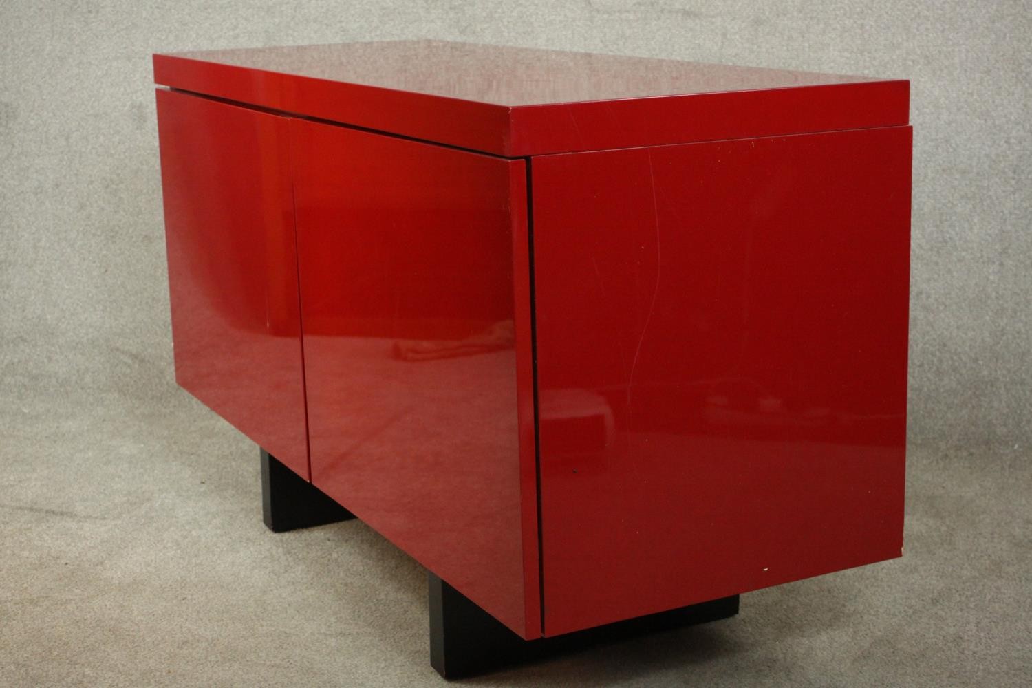 A contemporary red lacquered sideboard with two cupboard doors, on black lacquered supports. H.74 - Image 13 of 14