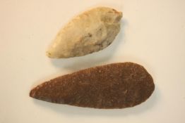 Two knapped flint spear heads, one created of white opaque flint and the other red/brown flint. L.17