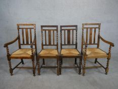 A set of four early 20th century oak dining chairs including two carvers, with carved and barley